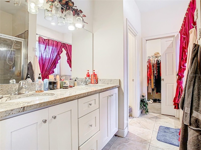 bathroom with vanity and a shower with shower door