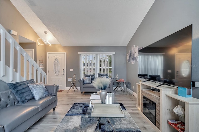 living room featuring light hardwood / wood-style flooring and vaulted ceiling