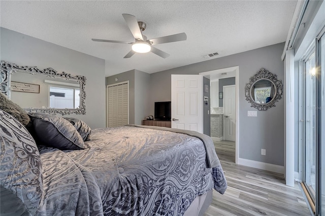 bedroom featuring ceiling fan, a closet, a textured ceiling, and light wood-type flooring