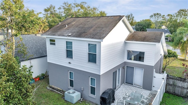 rear view of house featuring central AC