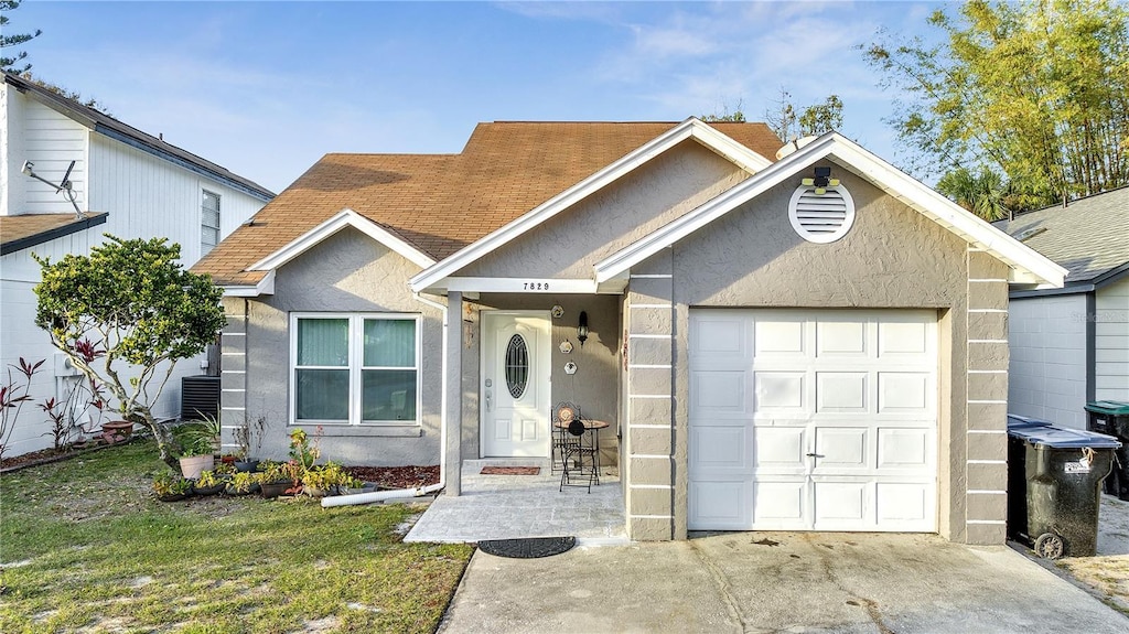 view of front of property with a garage and a front yard