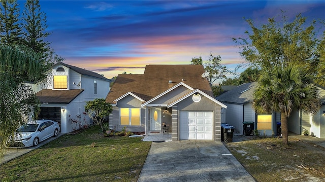 view of front of property featuring a garage and a lawn