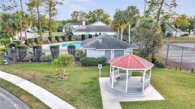 view of property's community with a gazebo, a swimming pool, and a lawn