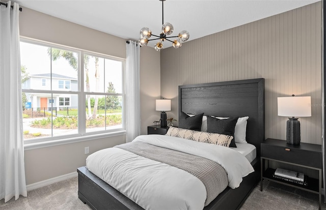 bedroom with carpet flooring and a chandelier