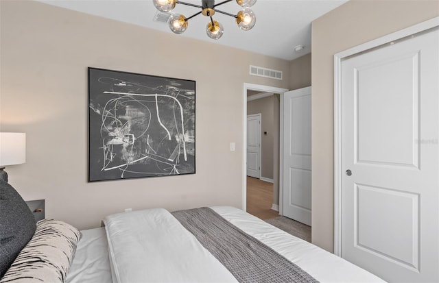 bedroom featuring an inviting chandelier