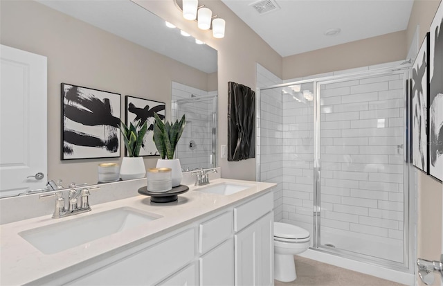 bathroom featuring vanity, toilet, and an enclosed shower