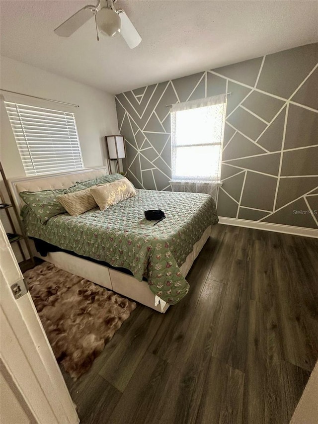 bedroom with wood-type flooring, a textured ceiling, and ceiling fan