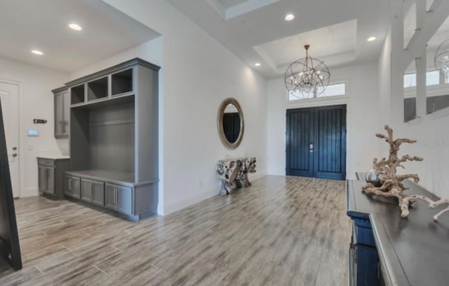 entryway featuring an inviting chandelier and wood-type flooring