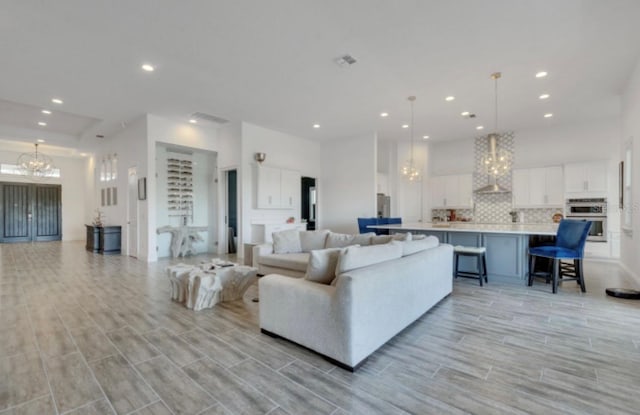 living room featuring a chandelier and a high ceiling