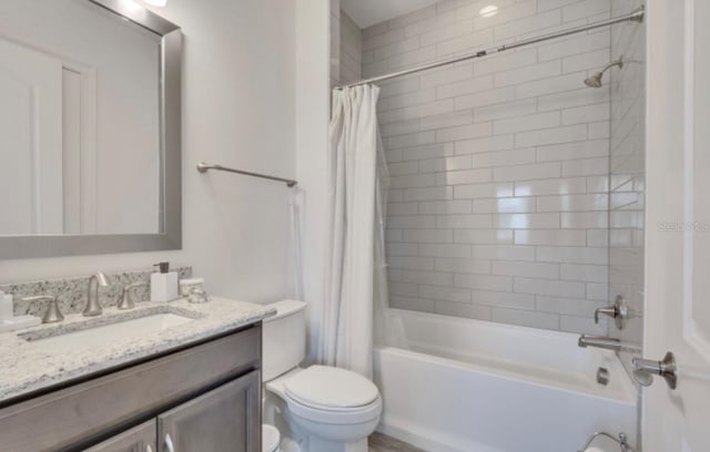 full bathroom featuring shower / tub combo, vanity, and toilet