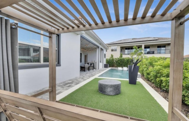 exterior space featuring a patio, a yard, and a pergola