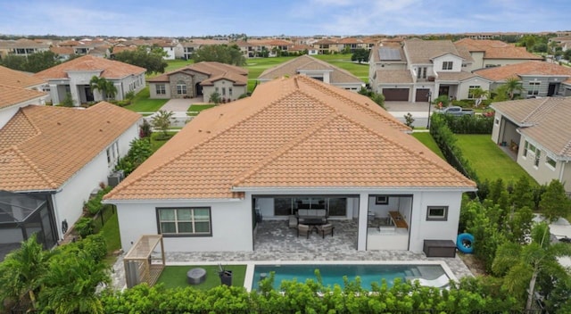 rear view of property featuring an outdoor living space and a patio