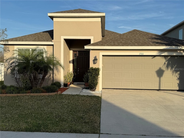 view of front of house featuring a garage and a front yard