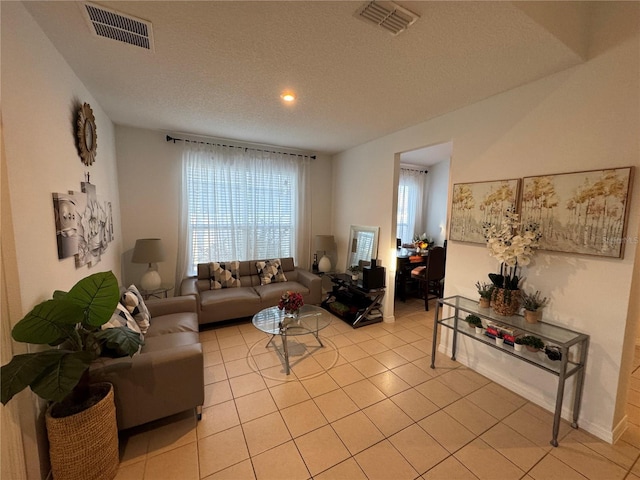 living room with light tile patterned floors and a textured ceiling