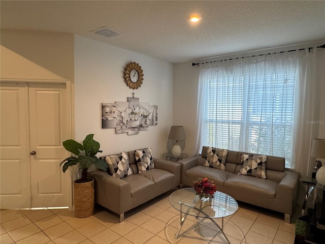 tiled living room with a textured ceiling