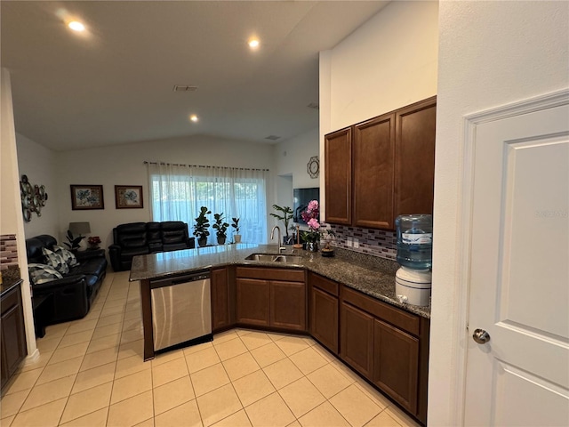 kitchen with sink, vaulted ceiling, light tile patterned floors, kitchen peninsula, and dishwasher