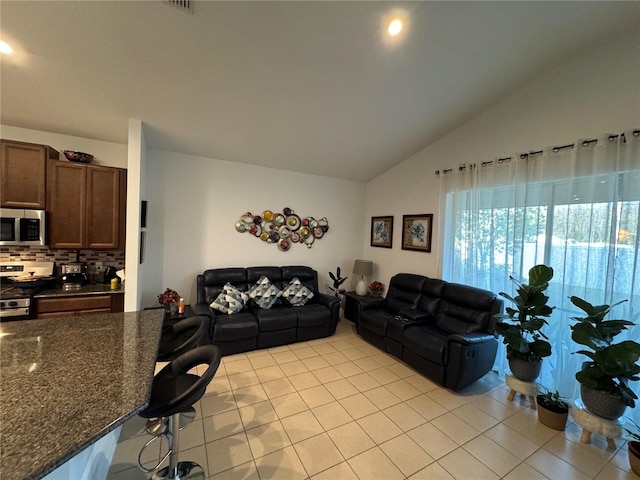 living room with lofted ceiling and light tile patterned flooring