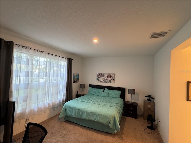 carpeted bedroom with a textured ceiling