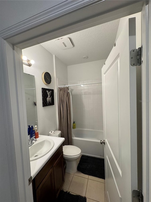 full bathroom with tile patterned flooring, vanity, toilet, shower / bath combo, and a textured ceiling