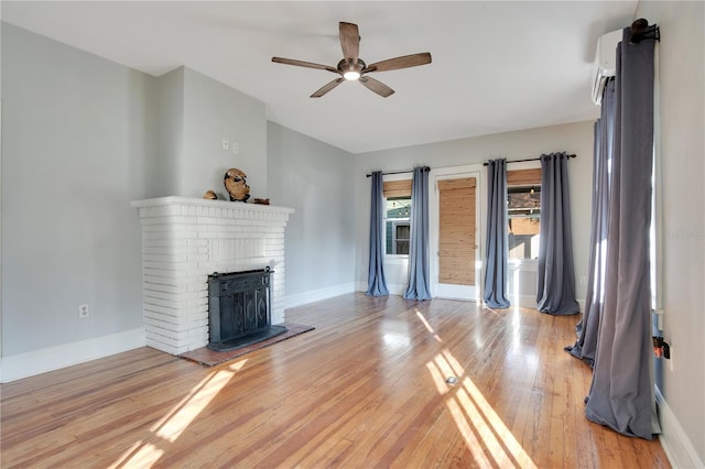 unfurnished living room featuring lofted ceiling, a brick fireplace, ceiling fan, and light wood-type flooring