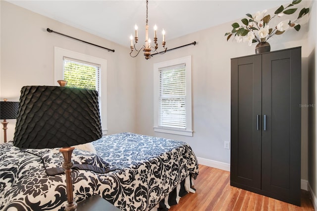 bedroom featuring light wood-type flooring and baseboards