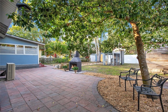 view of patio / terrace with a shed and cooling unit