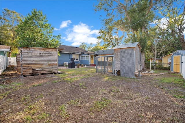 view of yard with a shed, exterior structure, a fenced backyard, and an outbuilding