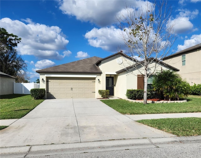 ranch-style home featuring a garage and a front lawn