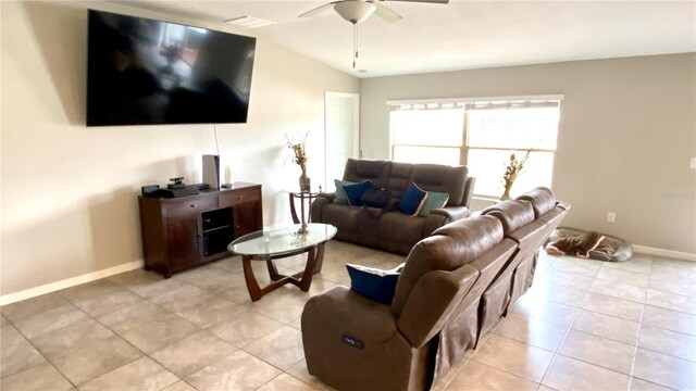 living room with vaulted ceiling, light tile patterned floors, and ceiling fan