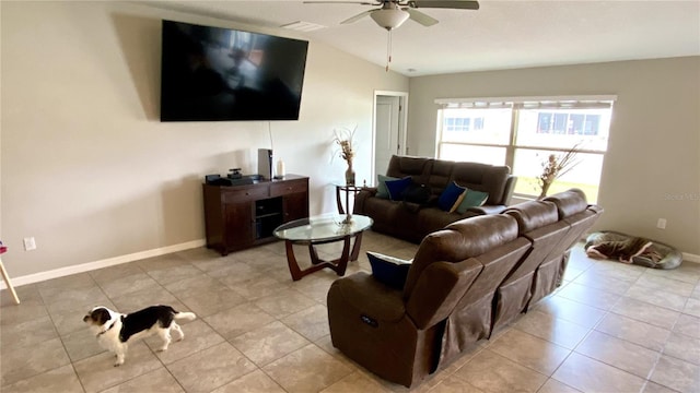 living room featuring ceiling fan, lofted ceiling, and light tile patterned floors