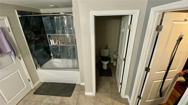 bathroom with tile patterned flooring, shower / tub combo, and toilet