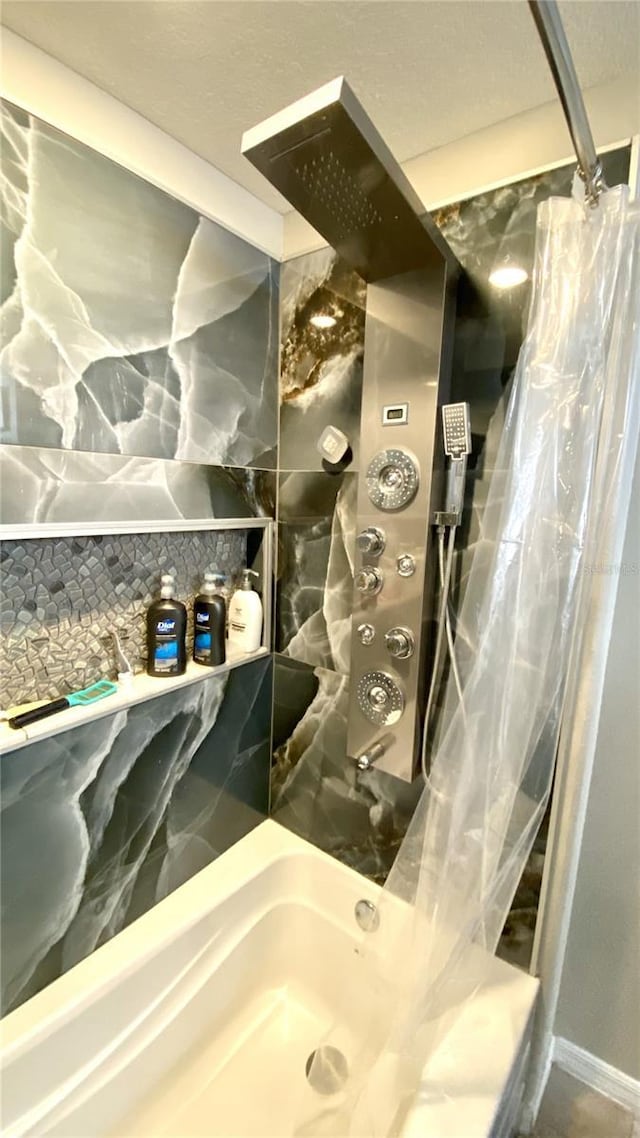 bathroom with shower / bath combination with curtain