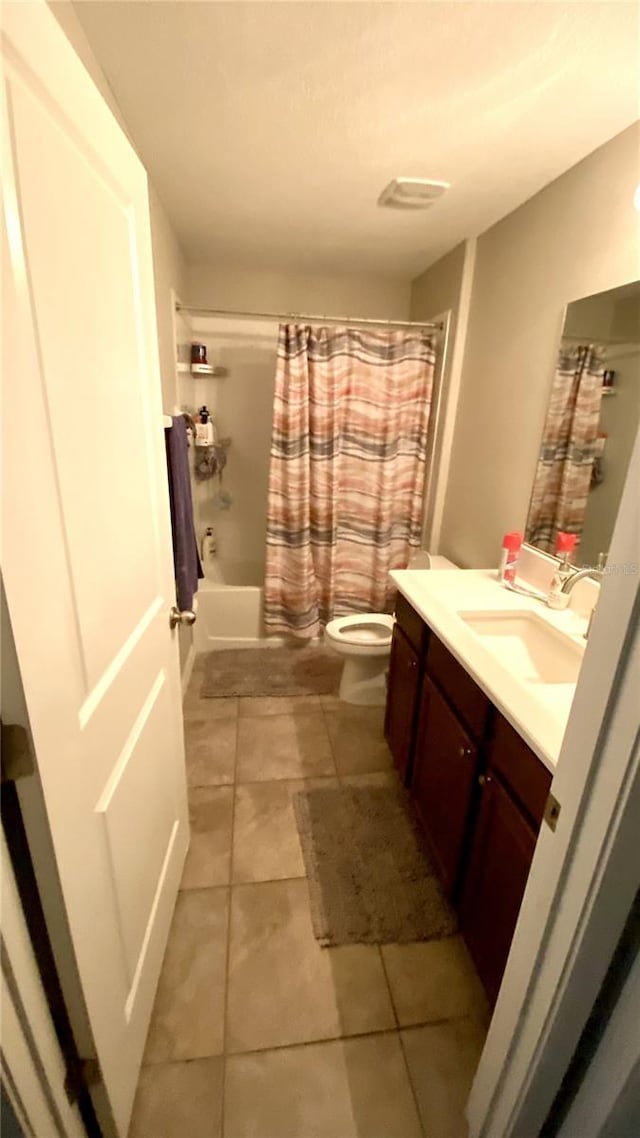 full bathroom featuring vanity, shower / tub combo, and toilet