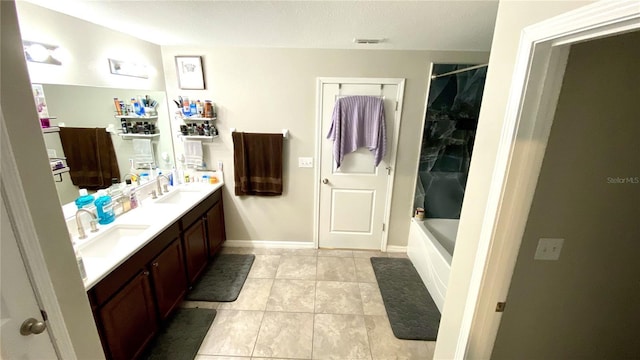 bathroom featuring vanity, tile patterned floors, and shower / washtub combination