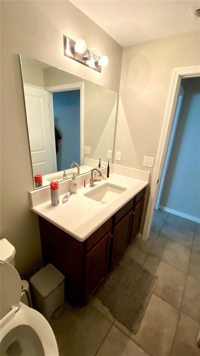 bathroom featuring vanity and toilet