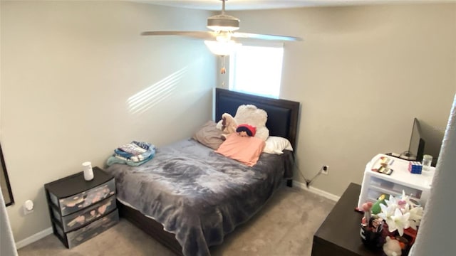 bedroom featuring light carpet and ceiling fan