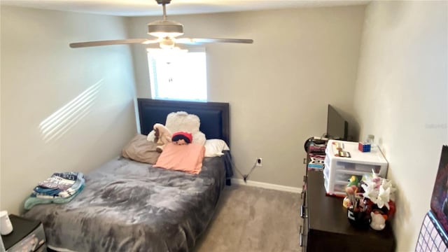 bedroom with ceiling fan and light carpet