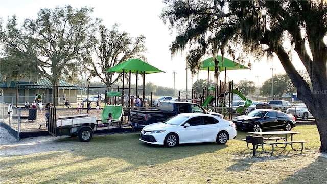 view of car parking with a playground