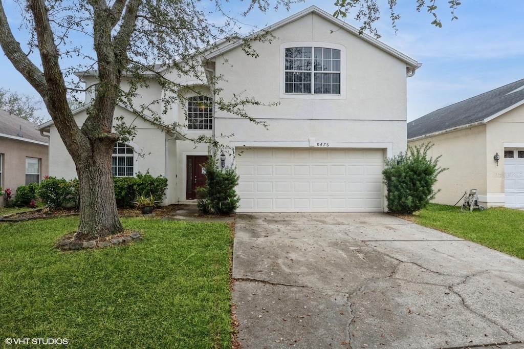 front of property with a garage and a front lawn