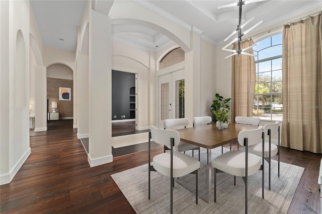 dining area with a notable chandelier, dark wood-type flooring, french doors, and a high ceiling