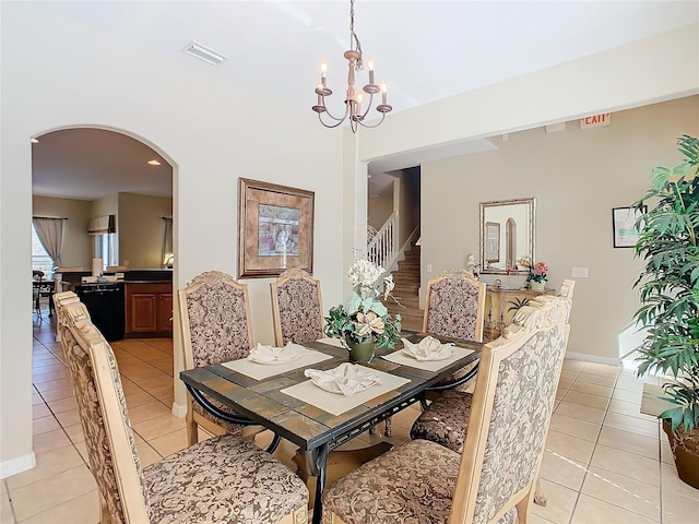 dining space with a notable chandelier and light tile patterned flooring