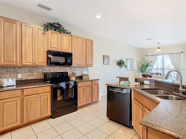 kitchen featuring pendant lighting, sink, backsplash, black appliances, and light stone countertops