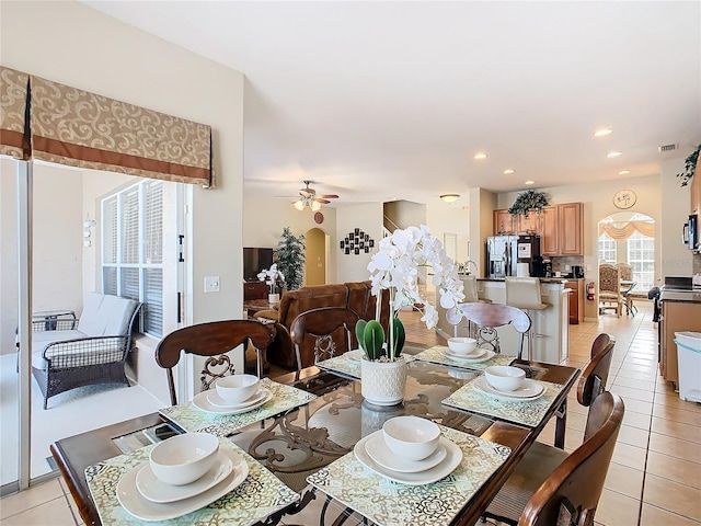 tiled dining area with ceiling fan