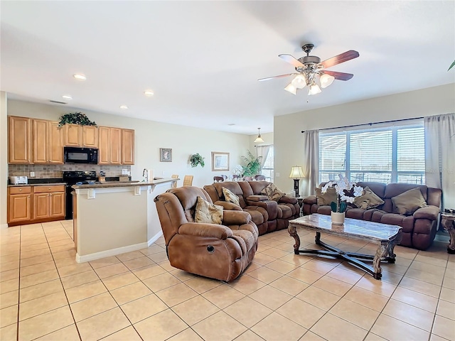 living room featuring light tile patterned floors and ceiling fan