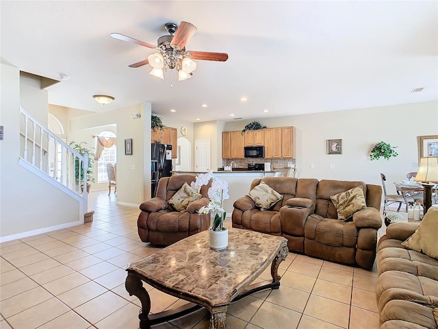 living room featuring light tile patterned floors and ceiling fan