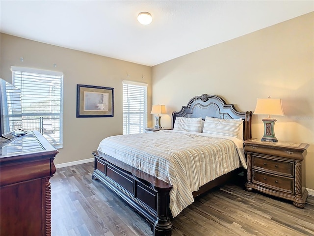 bedroom featuring dark wood-type flooring and multiple windows