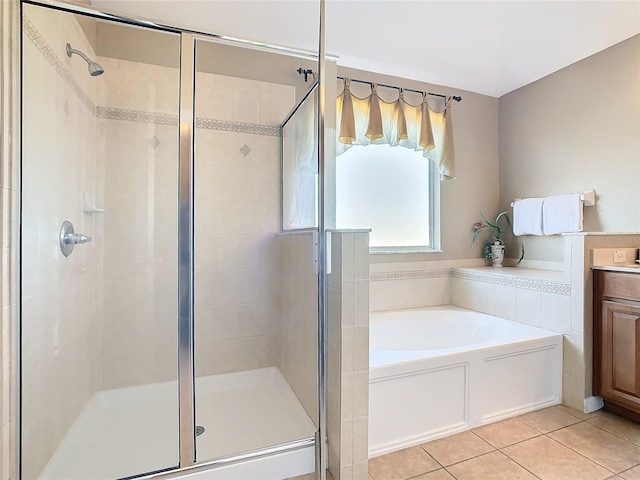 bathroom with vanity, tile patterned floors, and plus walk in shower