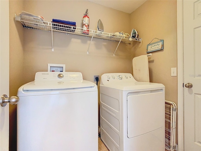 laundry area with independent washer and dryer