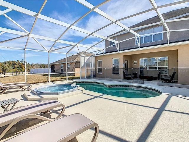 view of pool featuring an in ground hot tub, a lanai, and a patio