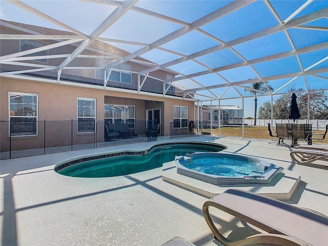 view of pool with an in ground hot tub, glass enclosure, and a patio area